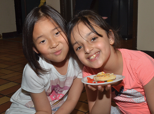 two young girls with a plate of snacks