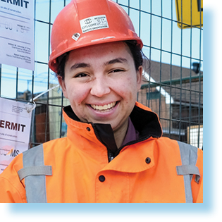young woman in construction helmet and vest